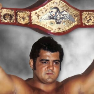 Pedro Morales hoists the WWWF Championship, embodying the raw passion of 1970s wrestling at Madison Square Garden.