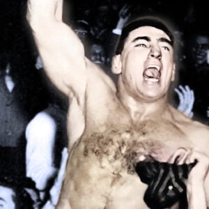 Antonino Rocca rides on the shoulders of fans after police break up the riot around the ring at Madison Square Garden on November 19, 1957.