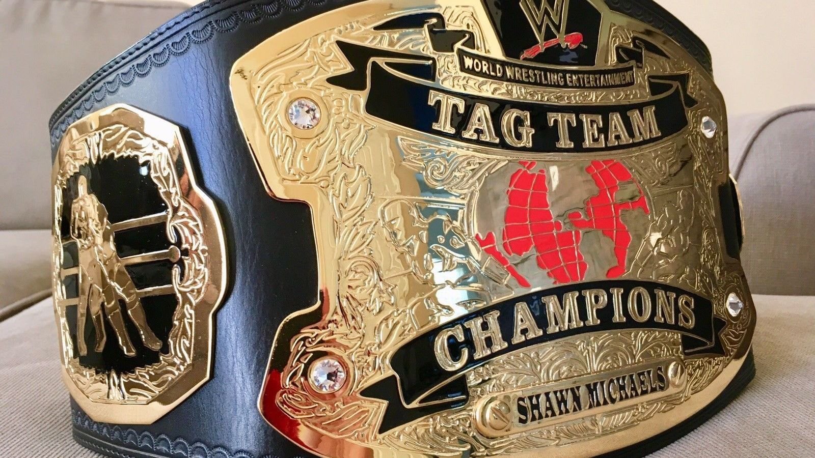 WWE World Tag Team Championship (2002–2010), first worn by Kurt Angle &amp; Chris Benoit, features deep gold plates and a globe motif, signifying tag-team world-class prestige. 