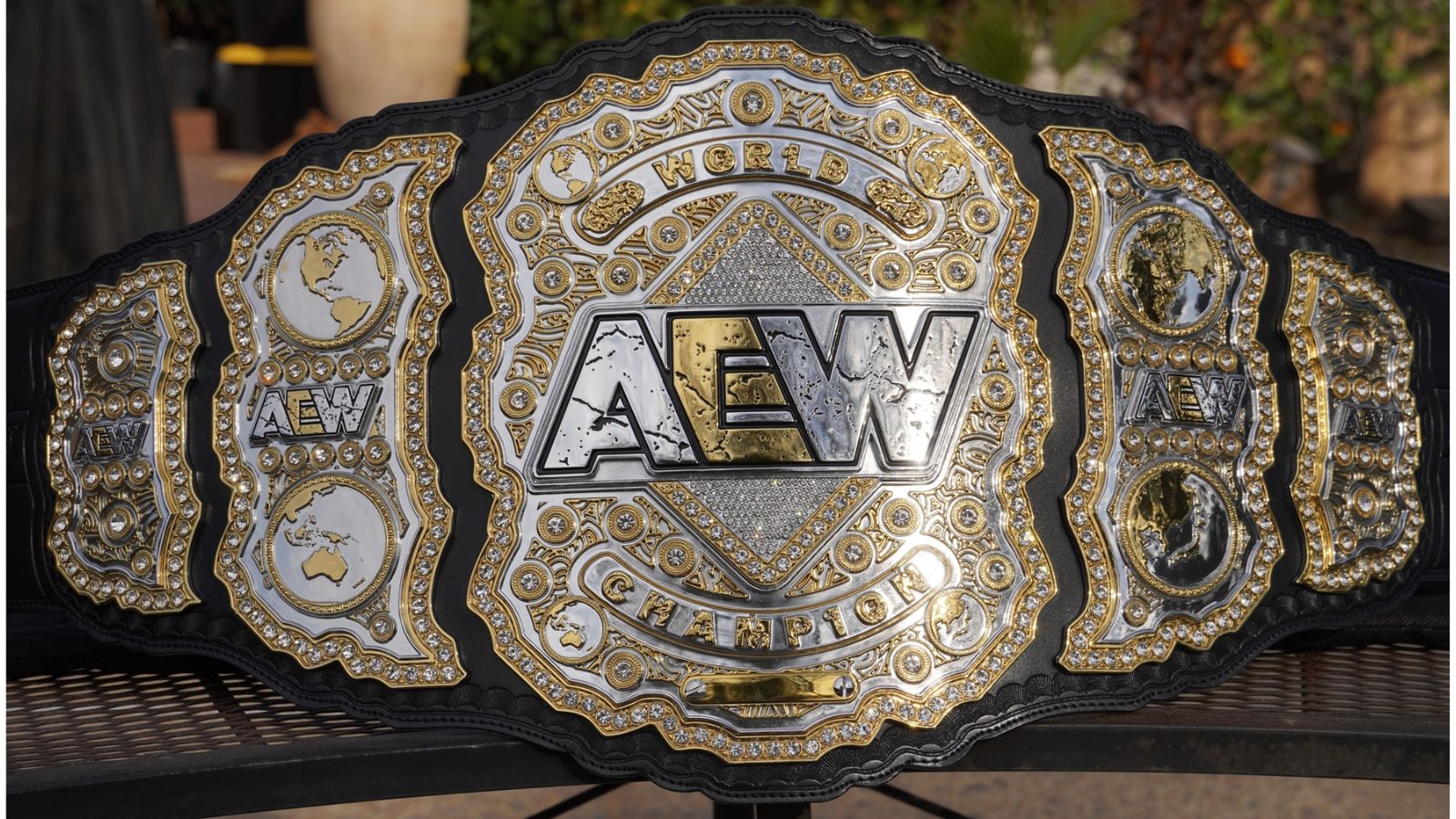 The AEW World Championship, which debuted in 2019 with Chris Jericho, features oversized, layered plates, gem accents, and Top Rope Belts craftsmanship, defining modern main-event gold. 