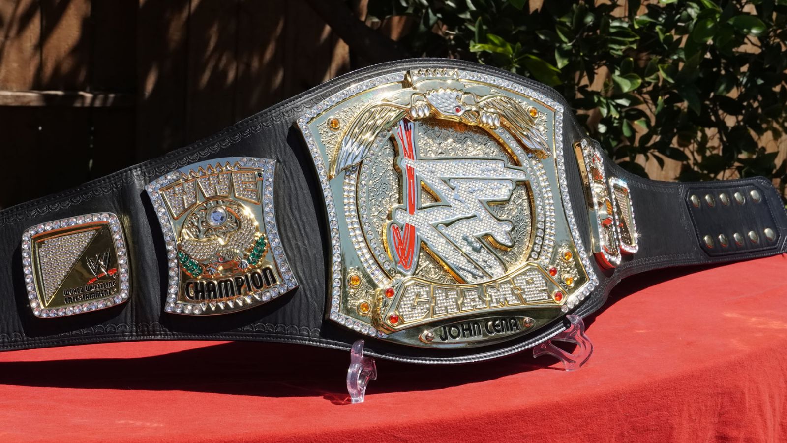 The WWE Spinner Championship, created in 2005 for John Cena, features a rotating WWE logo and jeweled chrome, epitomizing the Ruthless Aggression flair.