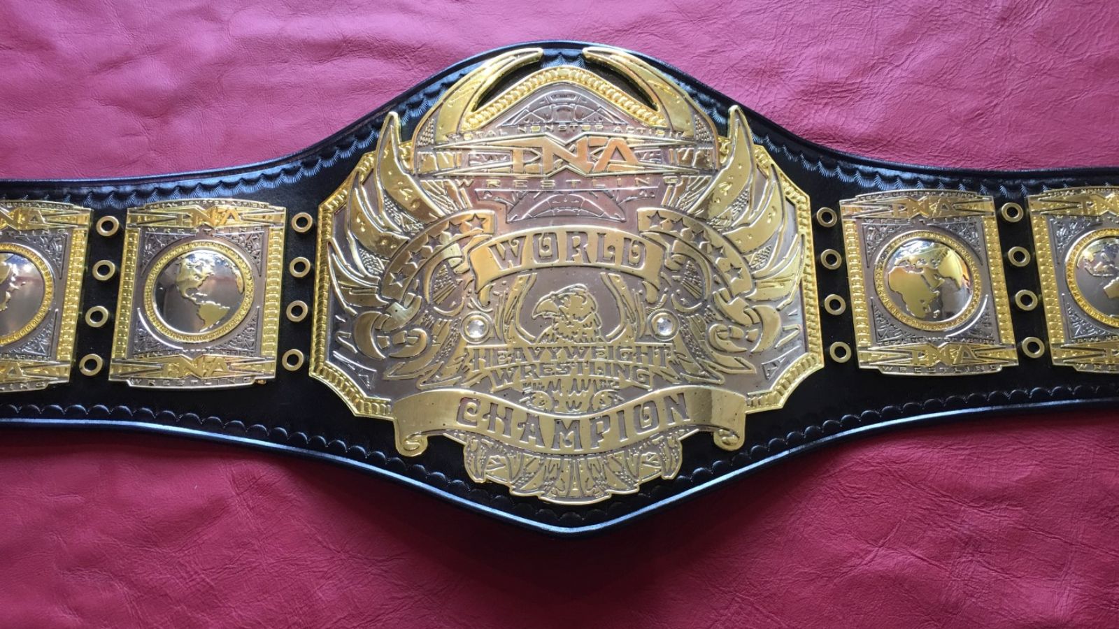 First TNA World Heavyweight Championship, premiered in 2007 by Kurt Angle, blends winged-eagle inspiration with bold 