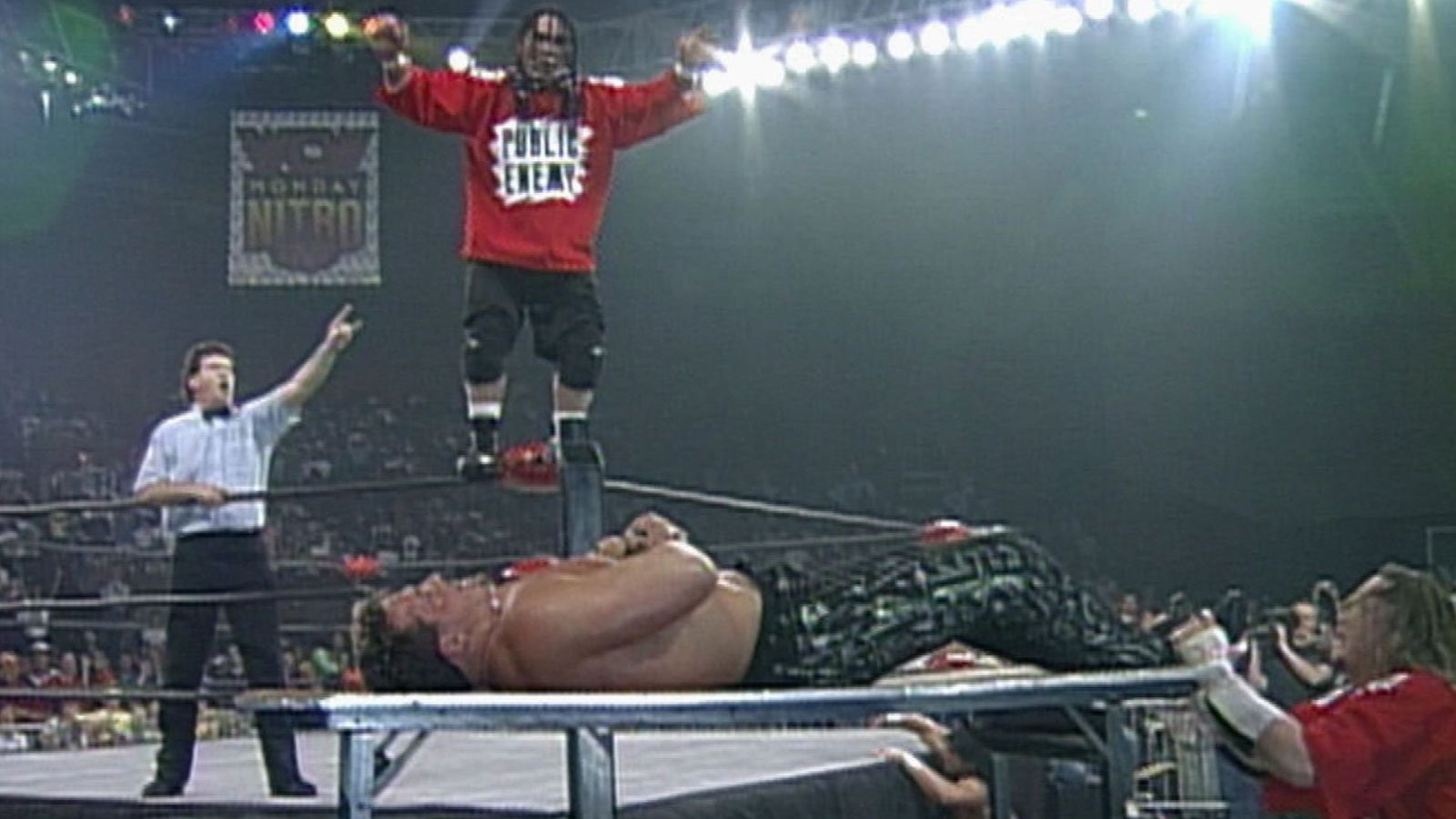 WCW Nitro, Jan. 15, 1996: ECW imports Public Enemy debut against The American Males (Marcus Bagwell & Scotty Riggs). Rocco Rock climbs to the top rope, launching onto Bagwell through a ringside table – a defining moment on primetime TV. 