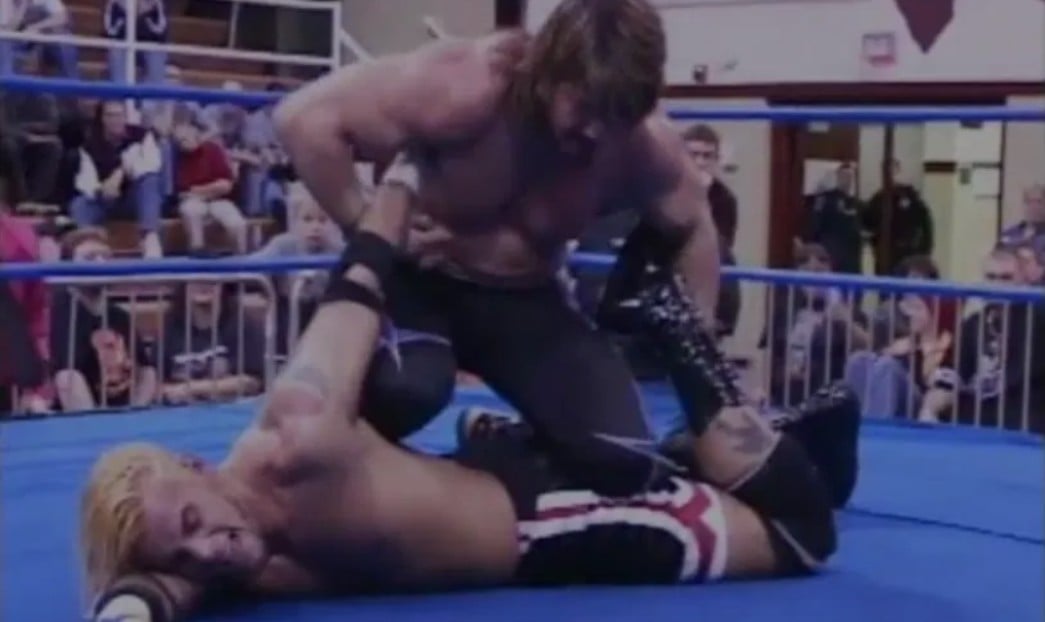 Eddie Guerrero dominates CM Punk with technical wrestling mastery during their career-defining IWA Mid-South Heavyweight Championship encounter in Morris, Illinois, March 2002. 