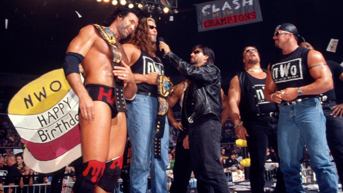 Scott Hall and Kevin Nash, The Outsiders, hold the WCW World Tag Team Championship while addressing the crowd during the nWo’s peak run in 1998. 