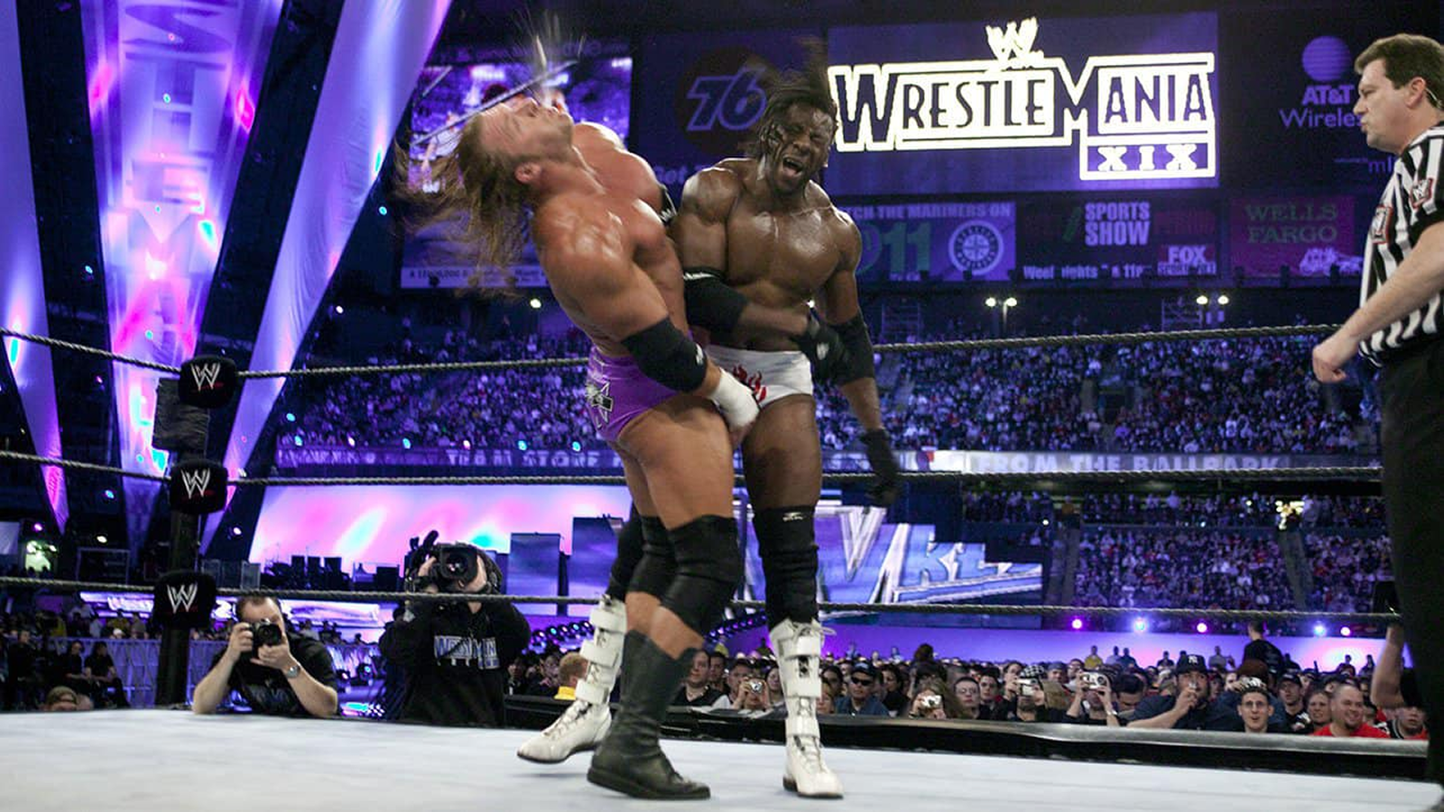 Booker T trades strikes with Triple H in their WrestleMania XIX World Heavyweight Title clash that ended in a disputed Pedigree pin. 