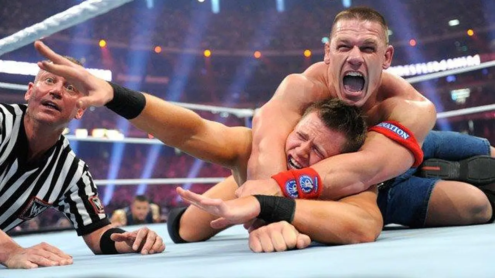 John Cena grapples The Miz for the WWE Championship at WrestleMania XXVII – the match overshadowed by The Rock’s post-bell ambush. 