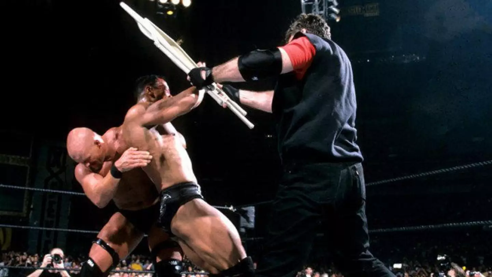 Stone Cold Steve Austin brandishes Vince McMahon’s chair to secure the WWE Title over The Rock, triggering a shocking heel turn at WrestleMania X-7. 