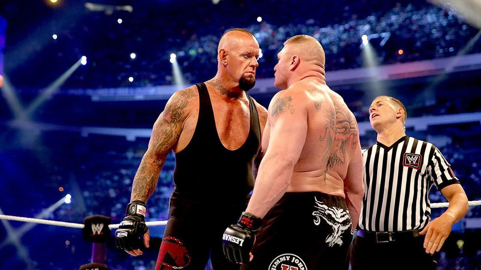 The Undertaker glares at Brock Lesnar moments before their WrestleMania 30 showdown that ended a 21-0 winning streak. 
