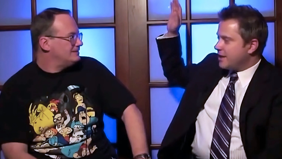 Legendary manager Jim Cornette (left) listens as Kayfabe Commentaries host Sean Oliver (right) poses a question during the 