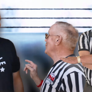 Kayfabe News creator Colin Hunter, seen here alongside noted WWE and TNA referee Earl Hebner, trades satire for stripes in the new documentary The Ref Didn’t See It! And reality hit him harder than expected.