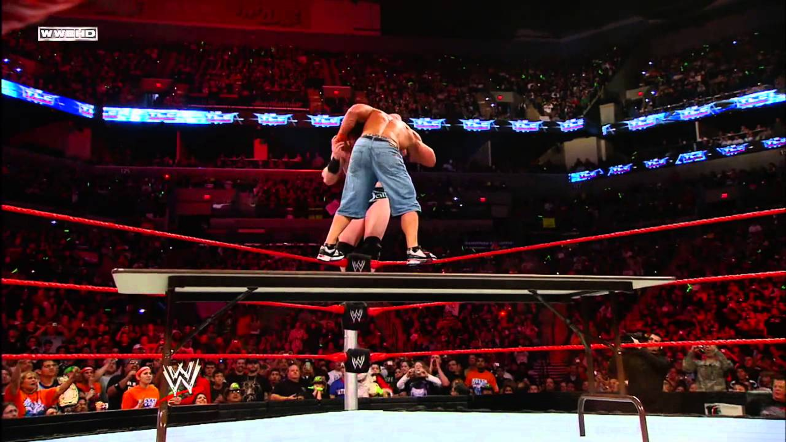 WWE TLC 2009: John Cena and Sheamus battle atop the turnbuckles in a Tables match for the World Title. Sheamus ultimately drives Cena through a ringside table to capture his first WWE Championship. 
