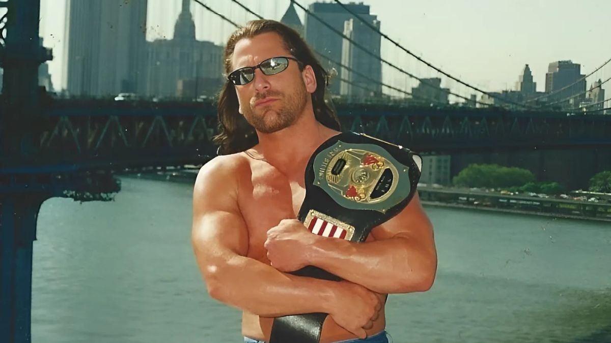 Chris Michaels (Bill Pierce) proudly displays the NWA New York Junior Heavyweight Championship belt in 2000, with his hometown of New York City skyline behind him.