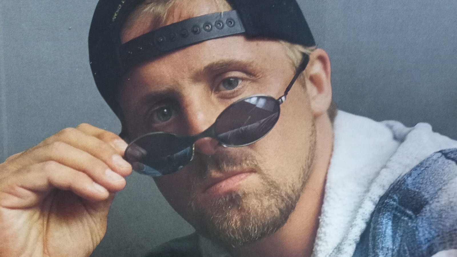 Owen Hart in an official WWF promo shot demonstrating a new 'Black Hart' moniker following the Montreal Screwjob. Unfortunately, due to plans already in motion at the main event level, the organic support Owen Hart had that could have elevated him to greater heights at this time were never really explored.