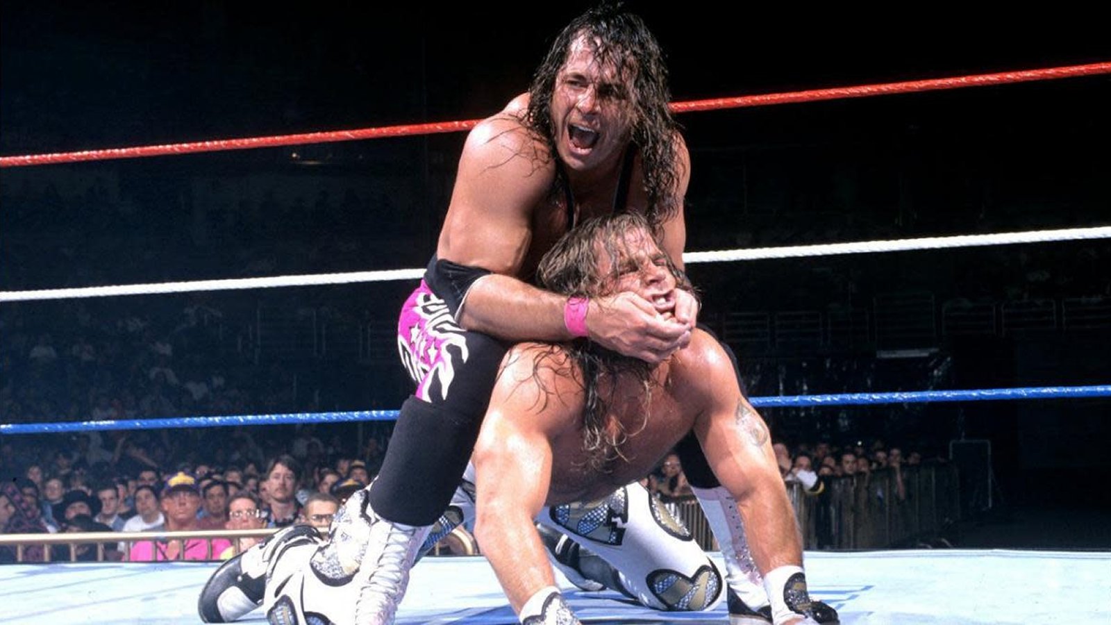 Bret Hart holds Shawn Michaels in a chin lock during their 60-minute Iron Man Match at WrestleMania XII, effectively bringing Bret Hart's multi-year main event level run to an end. When he returned later that year, the Hitman would never quite carry himself the same way.