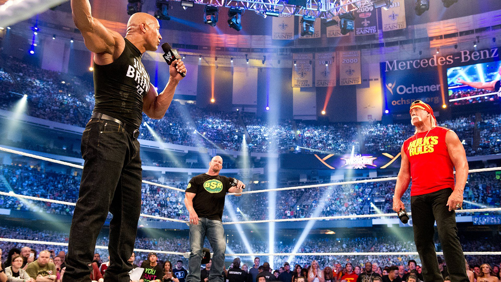 Hulk Hogan, Stone Cold Steve Austin, and The Rock share the ring during the opening segment of WrestleMania 30 on April 6, 2014, in New Orleans, Louisiana, marking the final WWE television appearance together for Rock and Stone Cold and celebrating their shared legacy. 