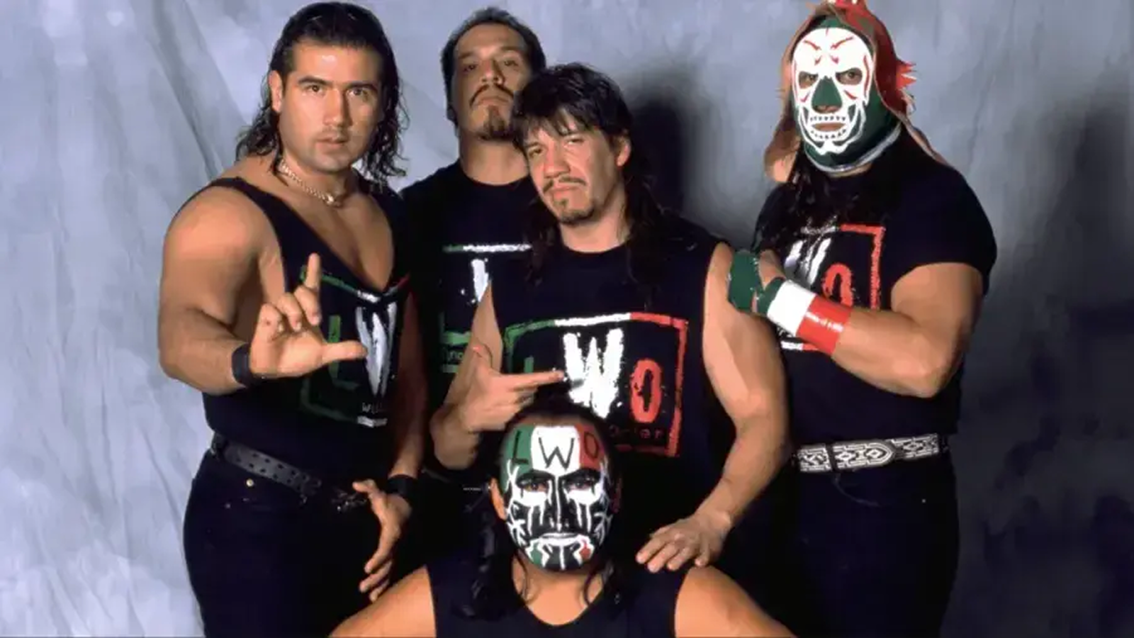 Eddie Guerrero led the Latino World Order with Mexican flag colors, standing alongside luchador wrestlers in WCW’s most significant Latino-focused faction that unified marginalized mid-card talent under one storyline.