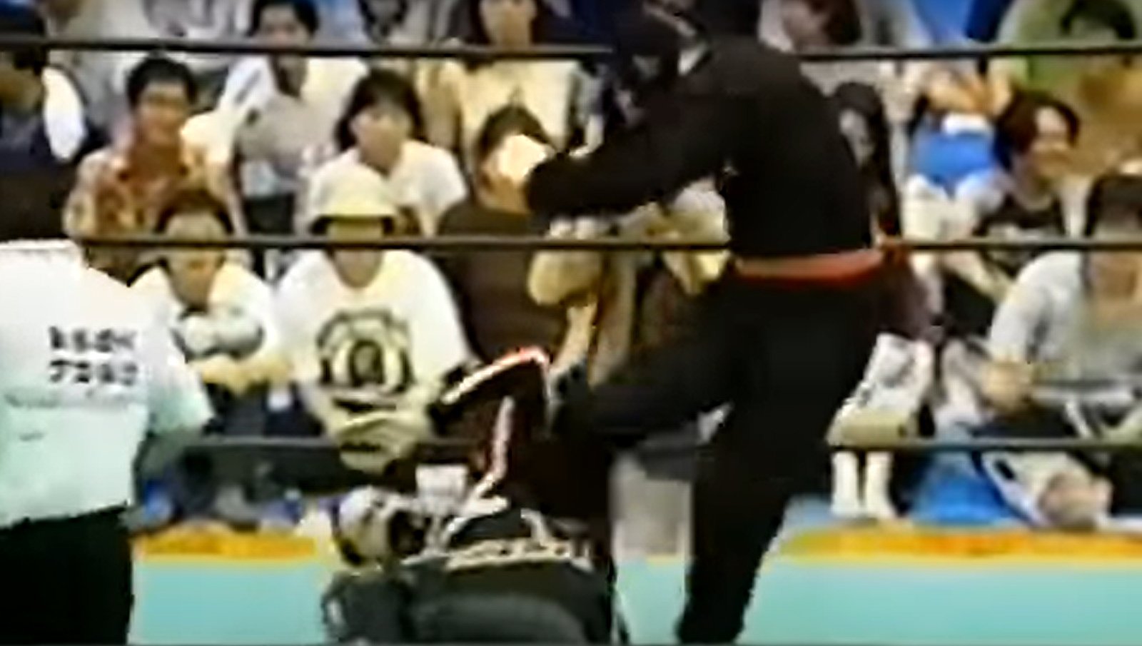 The Great Sasuke (Masanori Murakawa) demonstrates superior wrestling technique and physical dominance over Jason Harrison’s Dirtbike Kid during their infamous 1999 Michinoku Pro Wrestling encounter that became a case study in legitimate wrestling violence. P