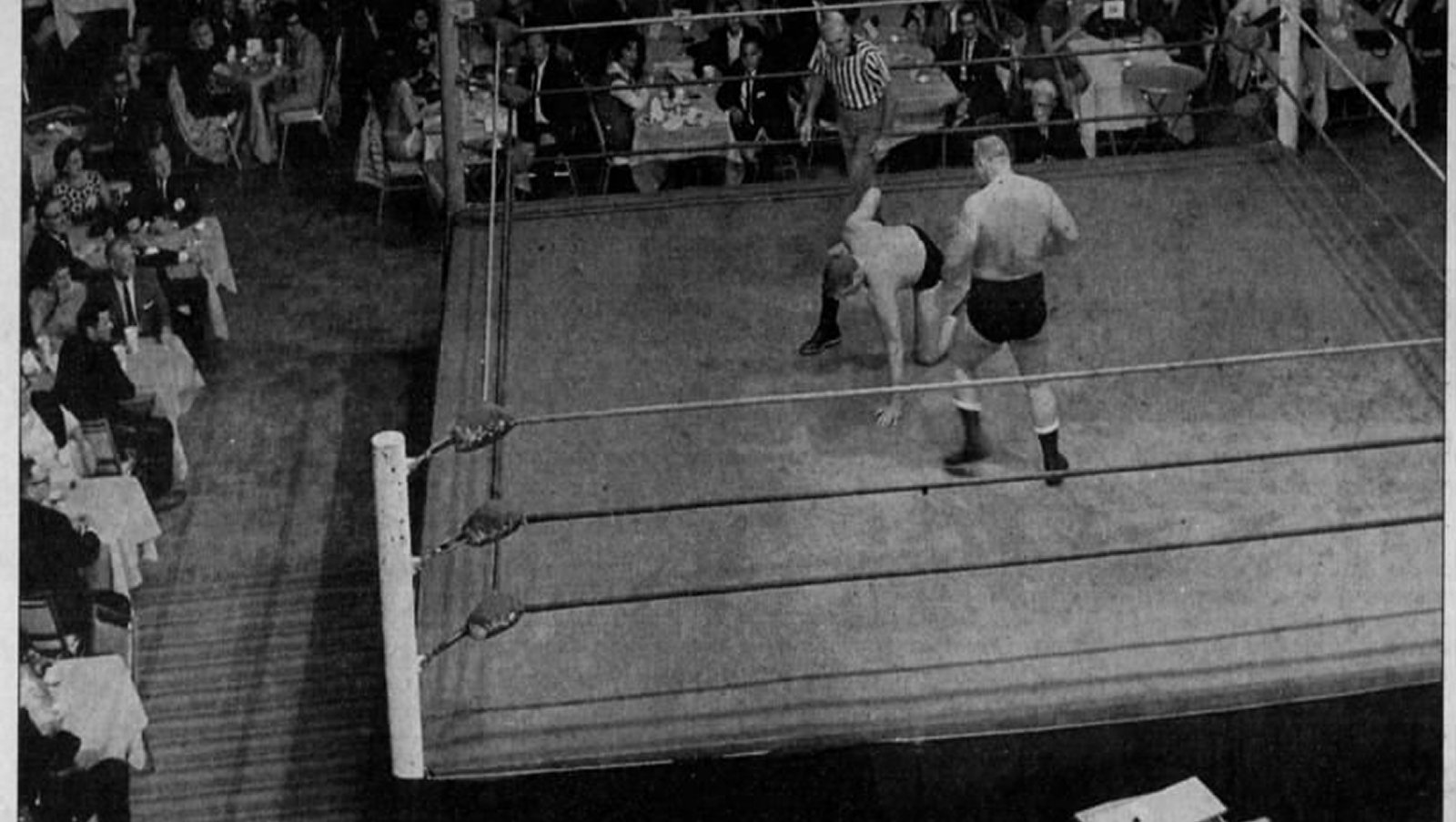 Bulldog Dick Brower has the upper hand over Guy Mitchell in a match refereed by Milo Occhi during a program of Wrestling at the Chase in the early 1960s. This was one of the most prestigious and well-known regional television programs during the Golden Era of territory pro wrestling.