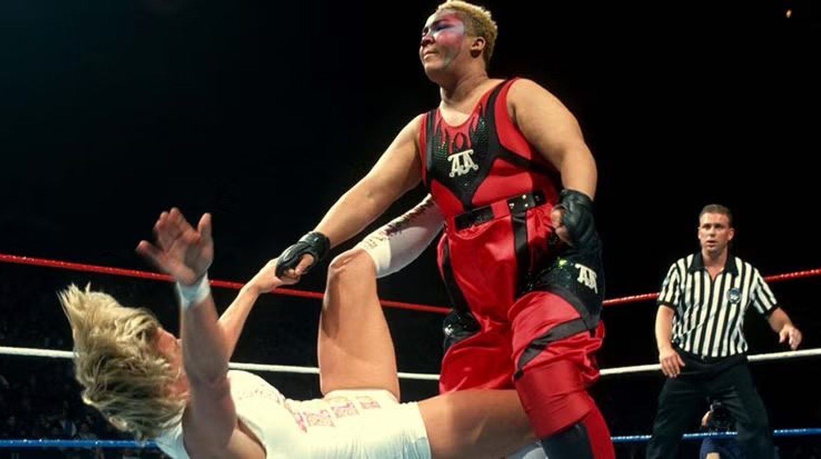 Aja Kong in a match against Alundra Blayze (Madusa) at a 1995 WWE event. Kong, one of AJW’s most dominant champions, represented joshi wrestling’s technical prowess on an international stage, though Western promotion failed to capitalize on her legacy. 
