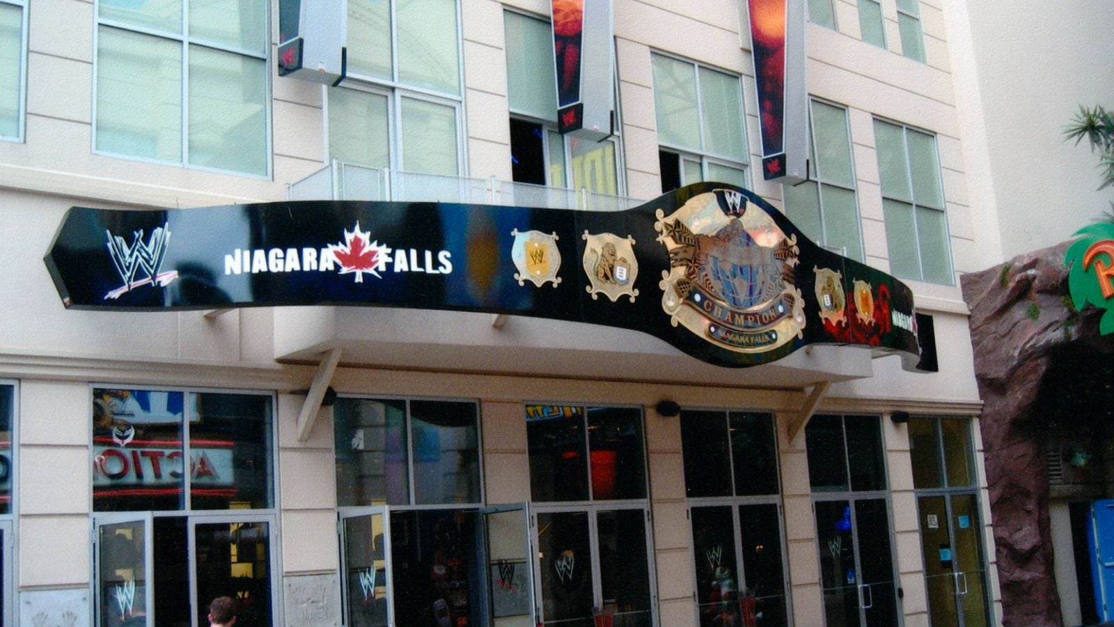 A giant WWE Undisputed Championship replica mounted on the exterior wall of the WWE Niagara Falls store. 
