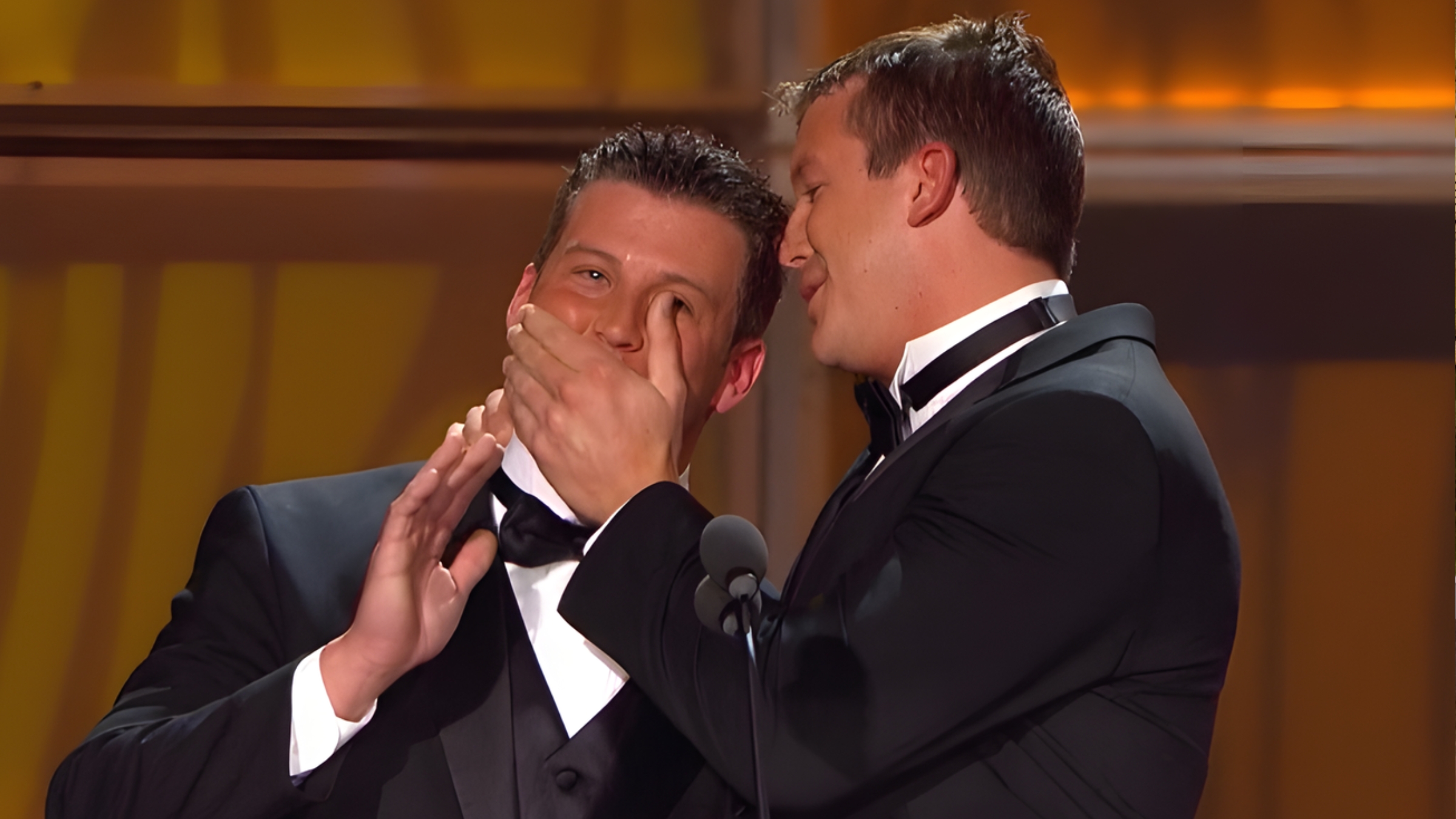 Brett DiBiase (left) and Ted DiBiase Jr. (right) share a moment at the 2010 WWE Hall of Fame induction ceremony celebrating their father. The brothers, once celebrated as part of a wrestling dynasty, now face federal charges and civil litigation connected to the Mississippi welfare scandal. 