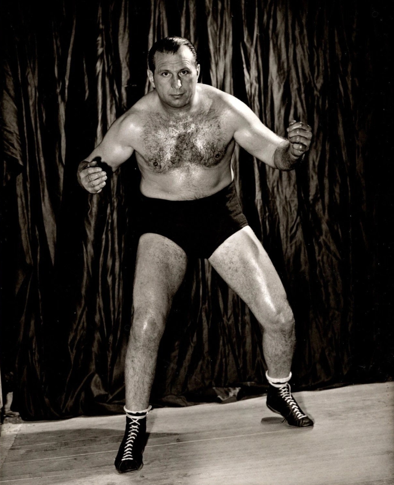 Wild Bill Longson, one of the early TV era’s most aggravating villains and a three-time NWA World Heavyweight Champion, helped set the blueprint for the smug heel who could ruin your night before the bell, and he is widely credited with popularizing the piledriver as a match ending weapon. 