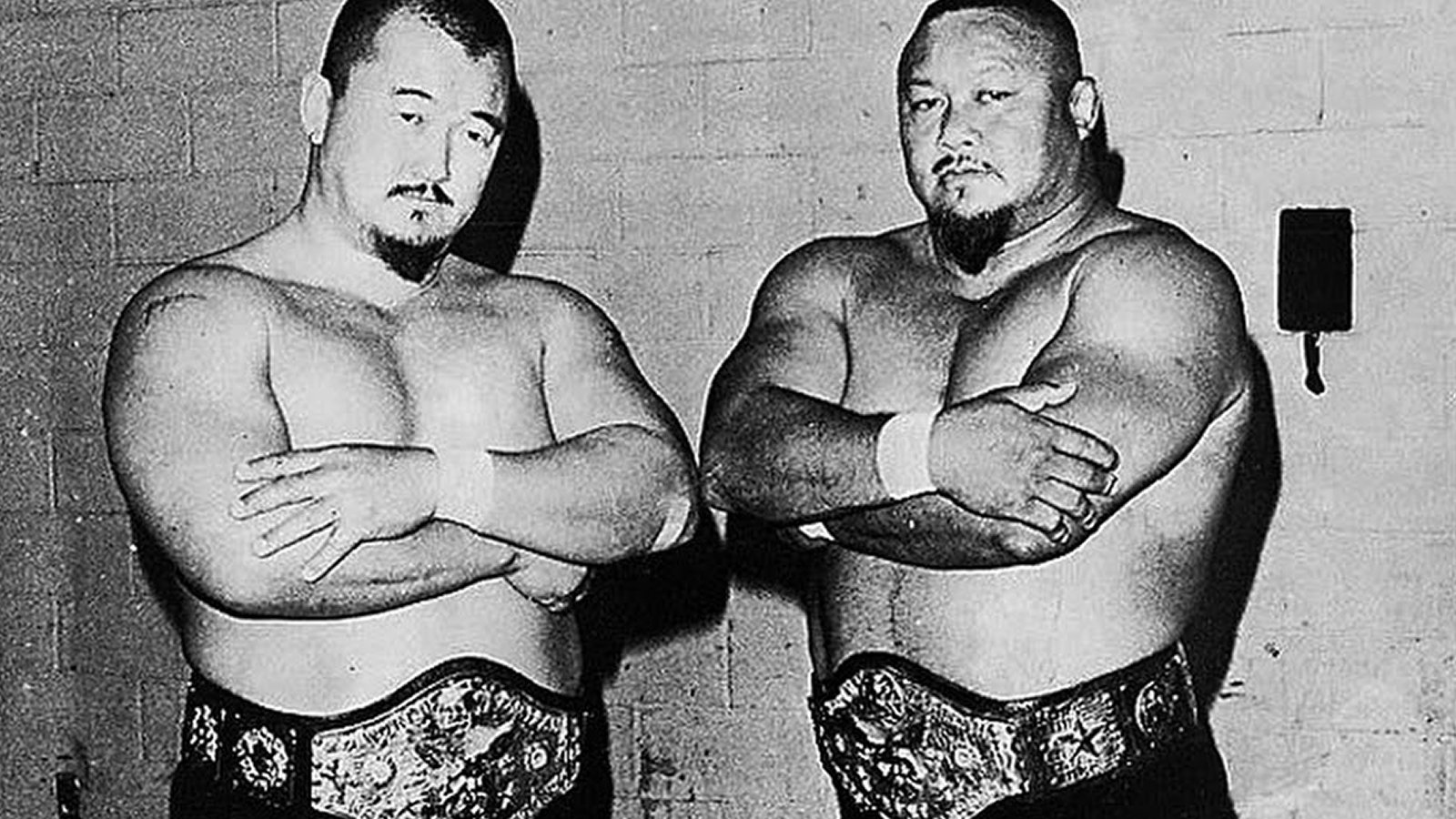 Professor Toru Tanaka (right) and Mr. Fuji hold the WWWF World Tag Team Championships after defeating Chief Jay Strongbow and Sonny King on June 27, 1972. The salt-throwing duo headlined Madison Square Garden throughout 1972–1973, capturing the tag titles twice and establishing themselves as one of the most dominant heel tag teams in 1970s WWWF history. 
