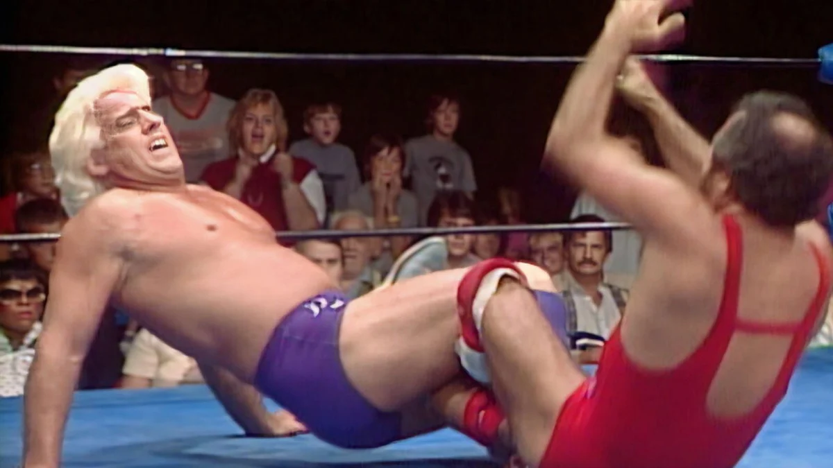 In 1986, Action Mike Jackson faces NWA World Heavyweight Champion Ric Flair on World Championship Wrestling, showcasing territory-era mat wrestling on national TV. 