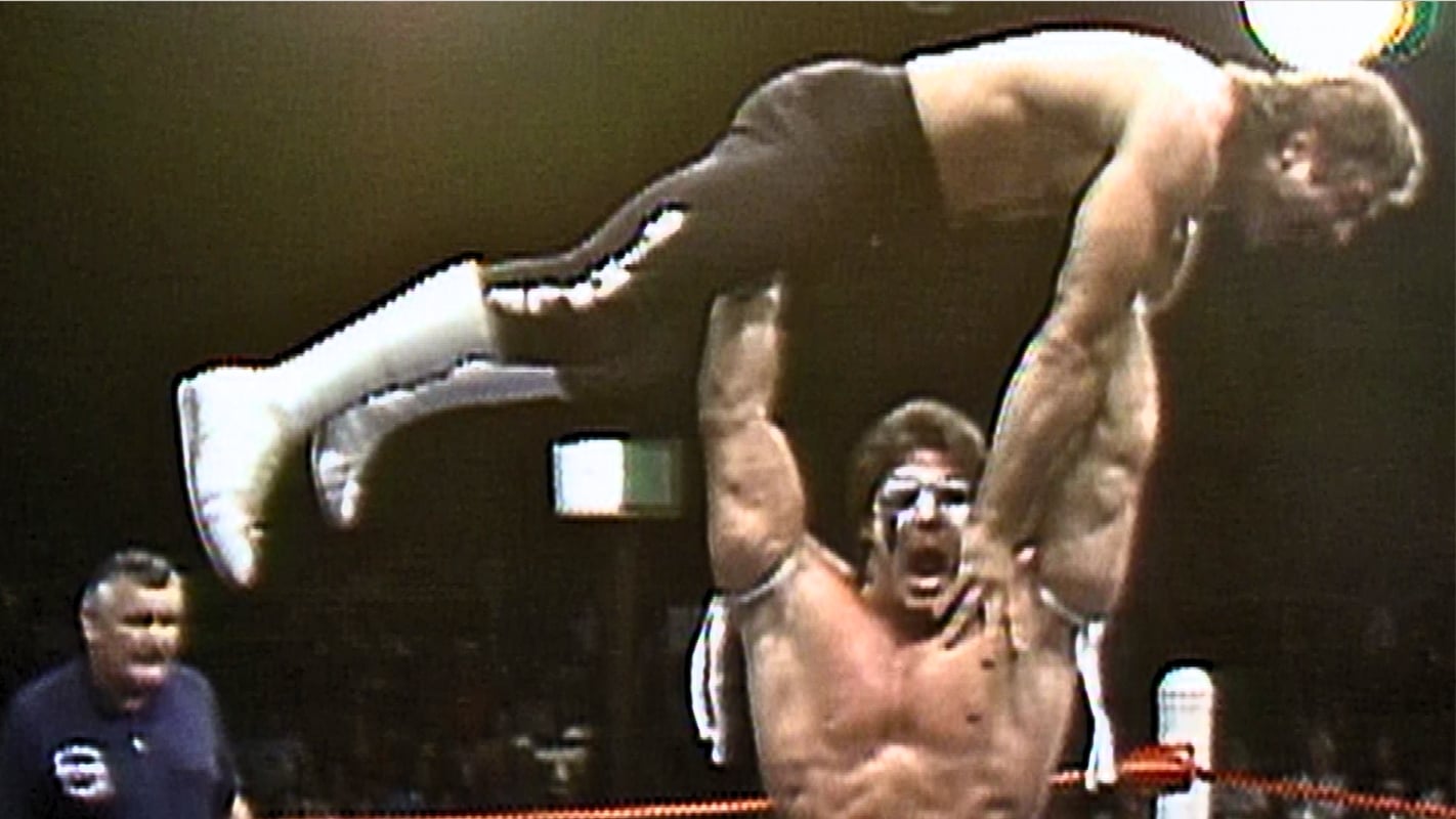 Dingo Warrior, later known as Ultimate Warrior, lifts Rick Rude high above the ring during their World Class Championship Wrestling match on August 30, 1986, years before their rivalry reached a much bigger stage in the WWF. 