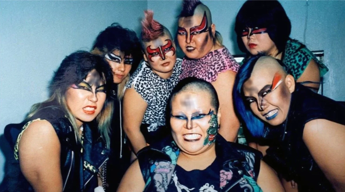 Dump Matsumoto stands with the Gokuaku Domei (Atrocious Alliance), including Bull Nakano and Condor Saito, the faction that defined heel wrestling in 1980s All Japan Women's Pro-Wrestling (AJW). Certain symbols visible in the original photograph have been obscured in accordance with editorial policy.