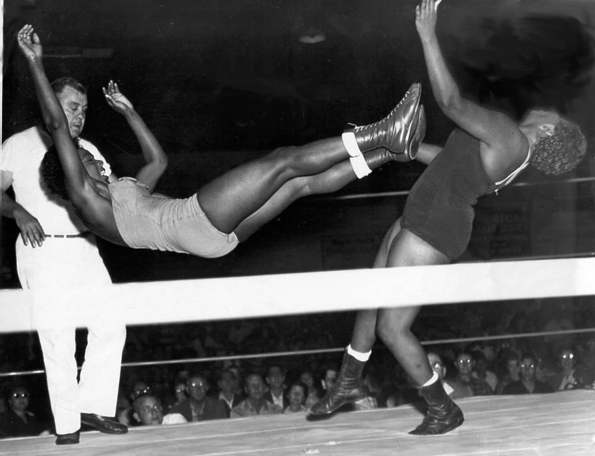 Ethel Johnson lands her famous standing dropkick on her older sister and frequent opponent Babs Wingo. The Columbus, Ohio sisters were among the first Black women to integrate 1950s professional wrestling.