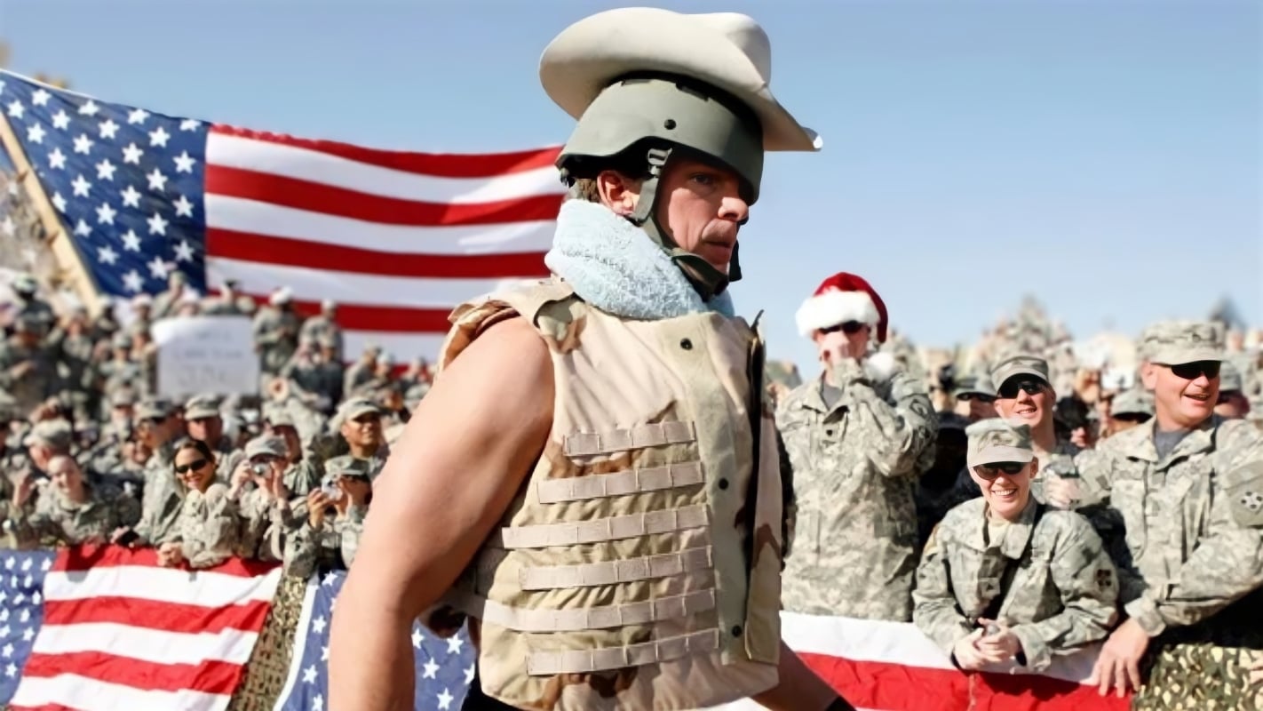 John "Bradshaw" Layfield wears his trademark cowboy hat over his military helmet during his entrance at WWE Tribute to the Troops 2008 in Iraq, the same tour that would end with his infamous real-life altercation with ECW announcer Joey Styles on the flight home.