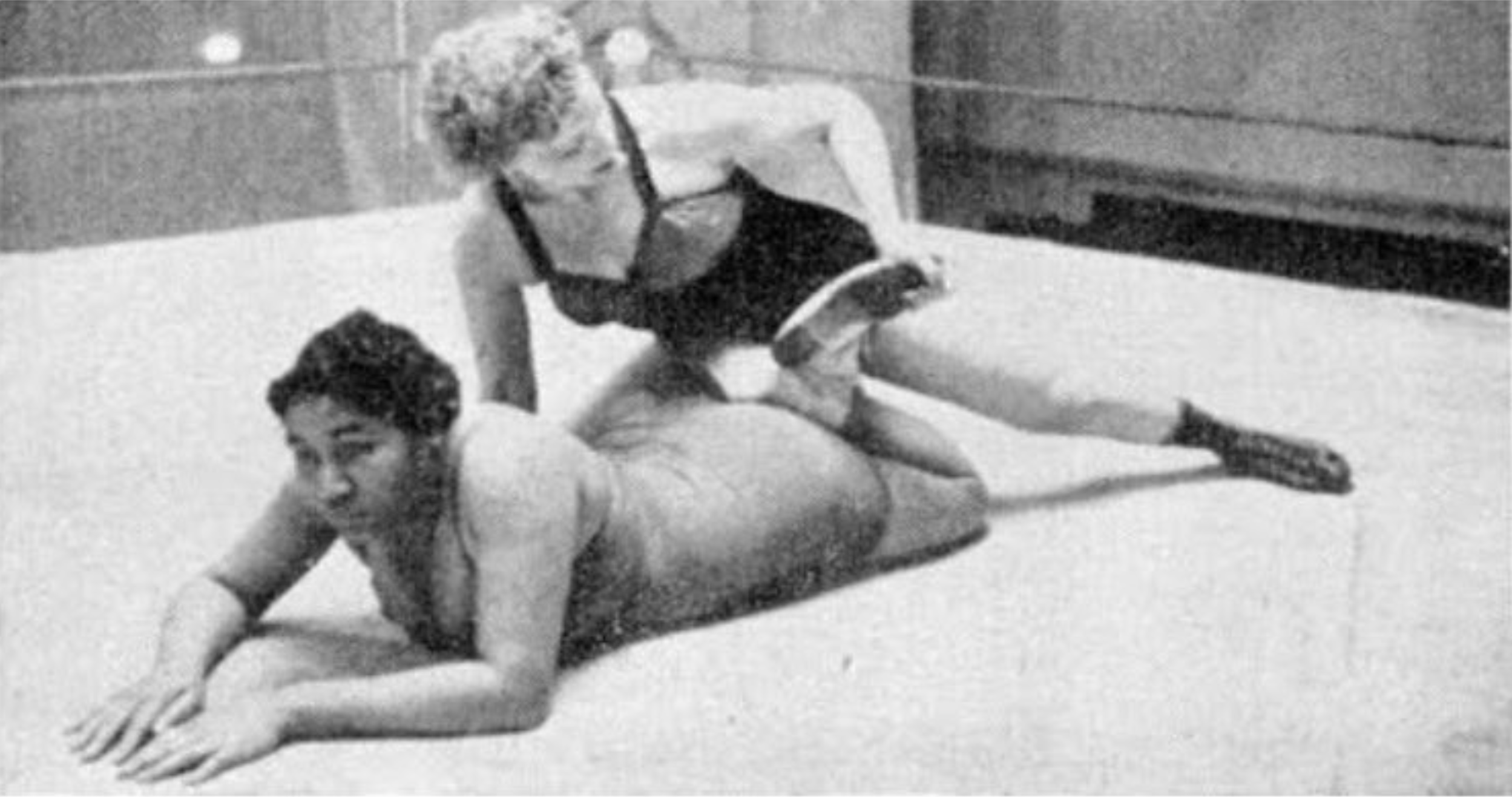 Mary Horton, a former college student whose off-the-mat interests ran to poetry and politics, trains with a stablemate from Billy Wolfe's troupe. As Jet magazine noted in February 1952, the two worked together without difficulty despite the racial divisions of the era.