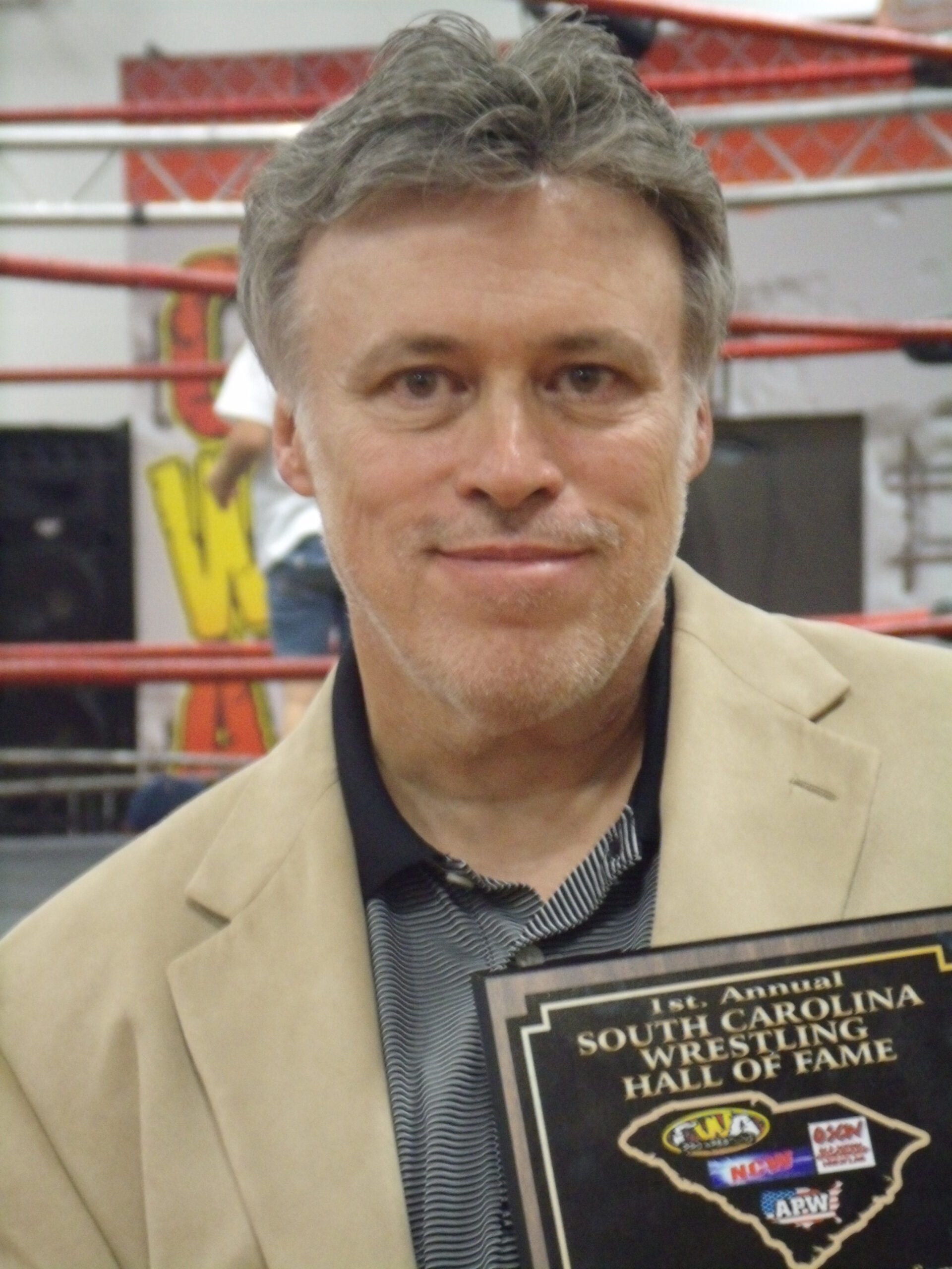Mike Mooneyham holds his South Carolina Wrestling Hall of Fame plaque, an honor that followed decades of respected writing about the sport.