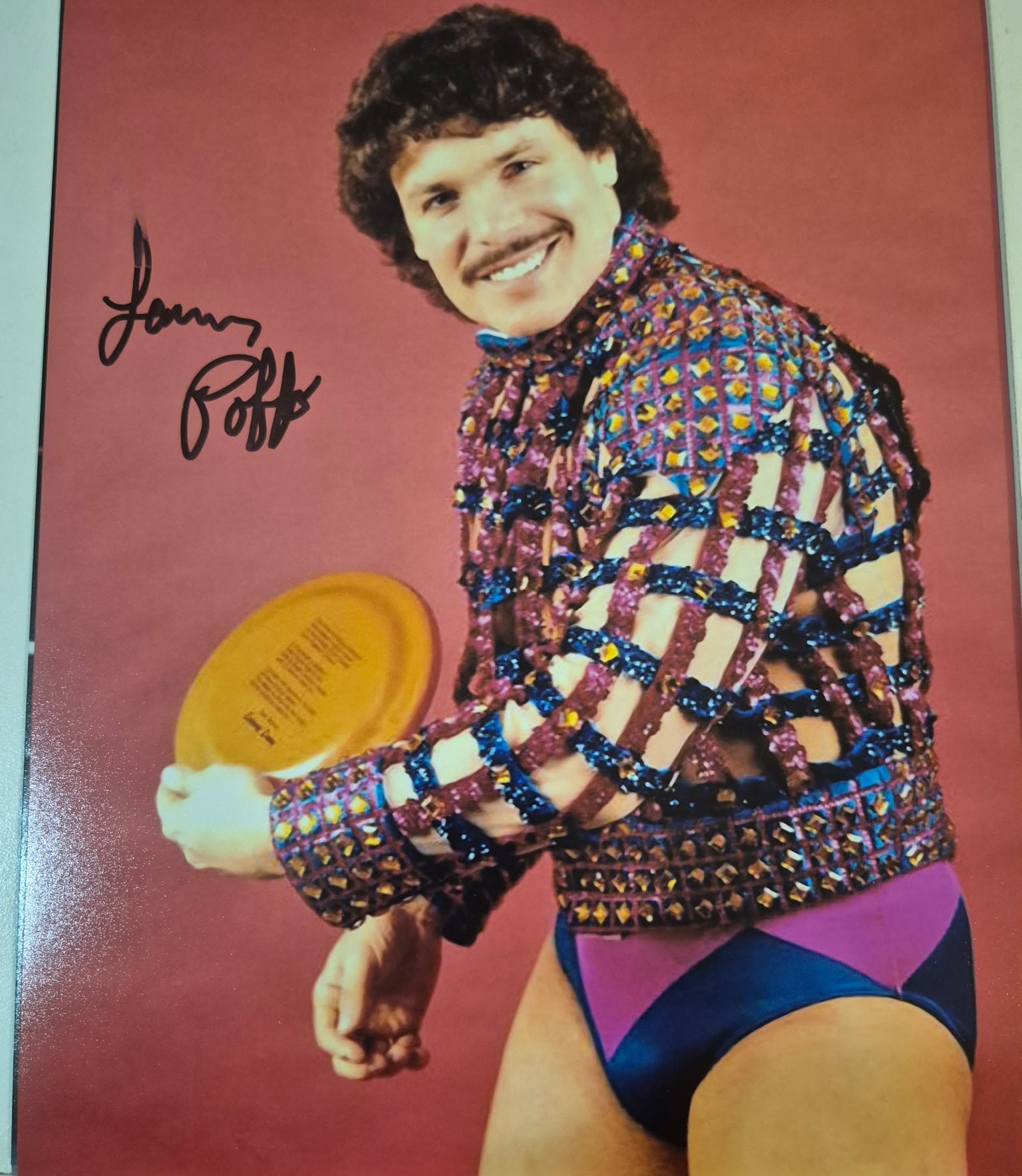 Own a piece of WWE history with this hand-signed 1986 vintage promo photo of “Leaping” Lanny Poffo, “The Genius,” brother of Macho Man Randy Savage.