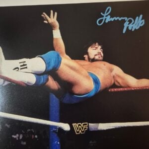 Own a piece of WWF history with this hand-signed vintage promo photo of "Leaping" Lanny Poffo, brother of Macho Man Randy Savage, captured posing across the top rope.