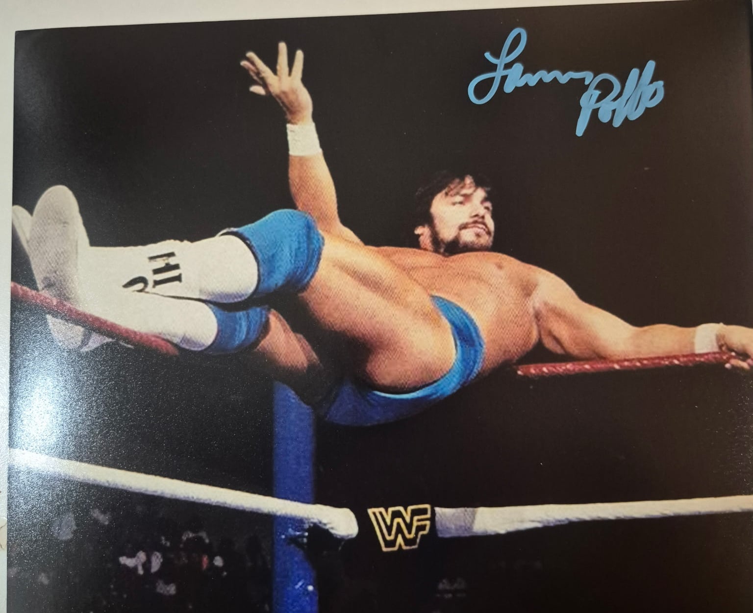 Own a piece of WWF history with this hand-signed vintage promo photo of "Leaping" Lanny Poffo, brother of Macho Man Randy Savage, captured posing across the top rope.